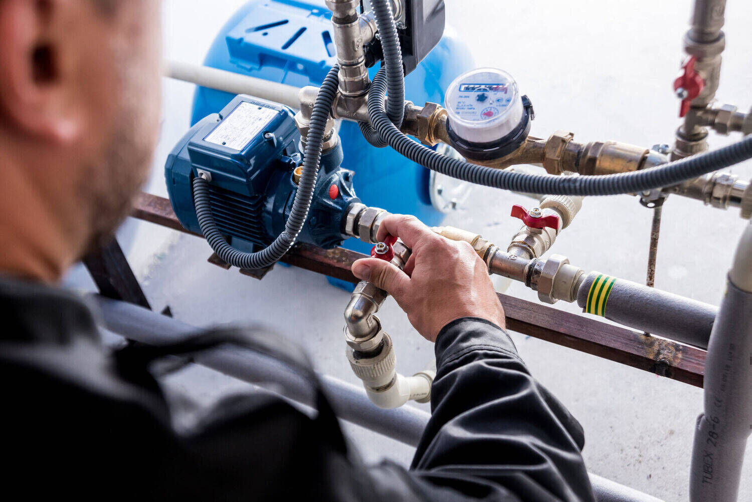 Installateur arbeitet an einer Wasserpumpe